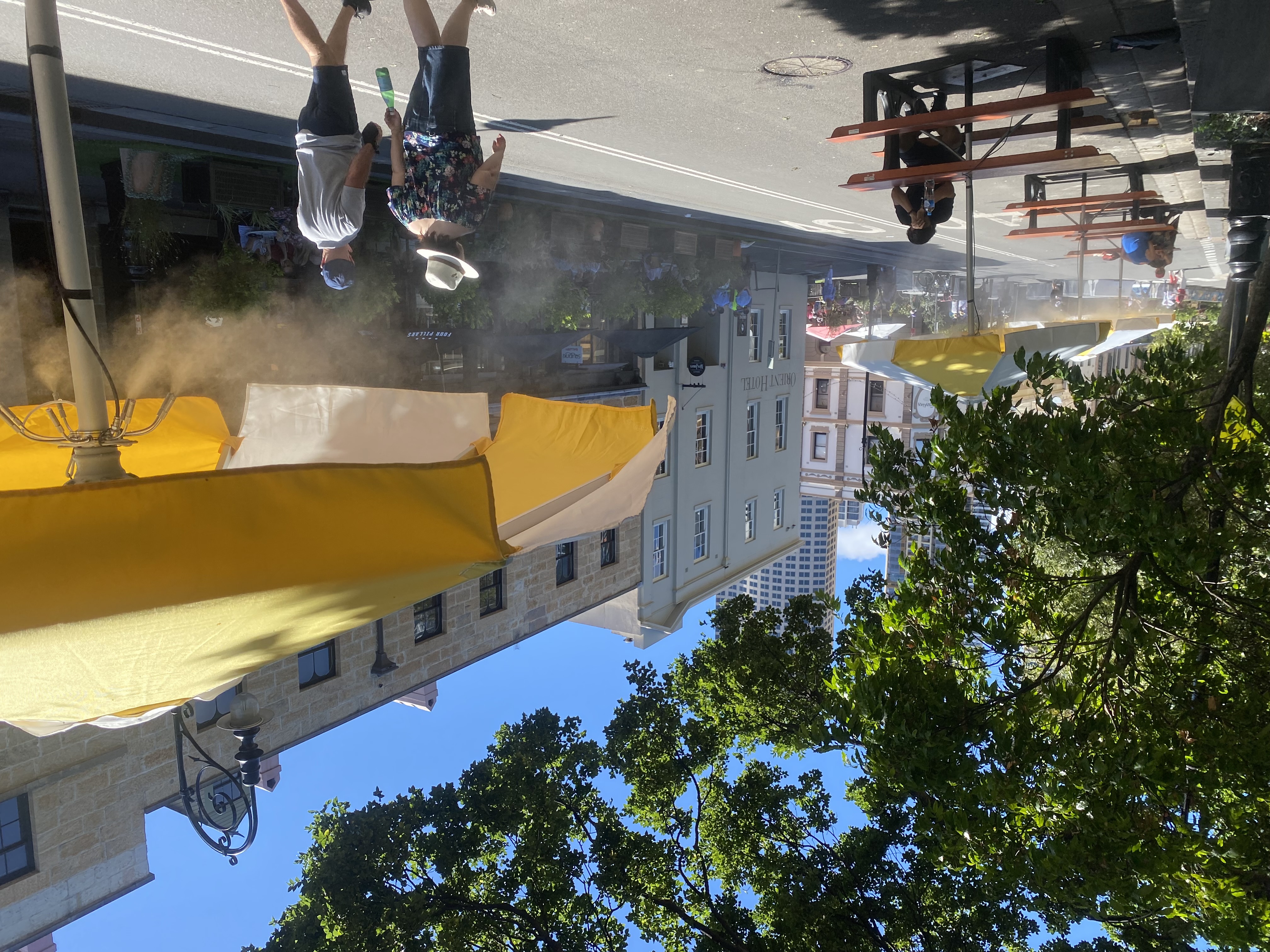 Catenary misting system over outdoor dining street