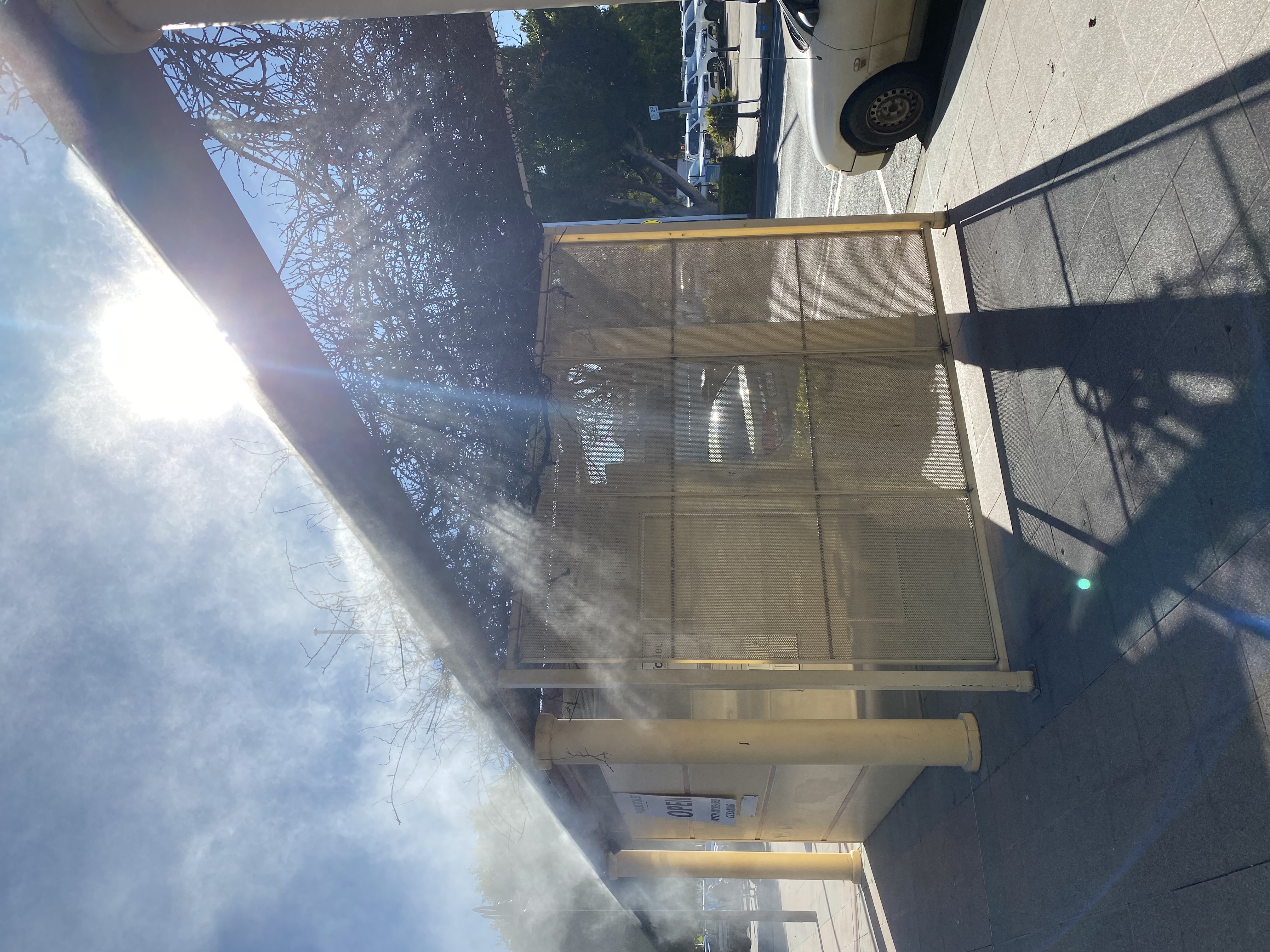 Fixed perimeter misting lines at outdoor shelter