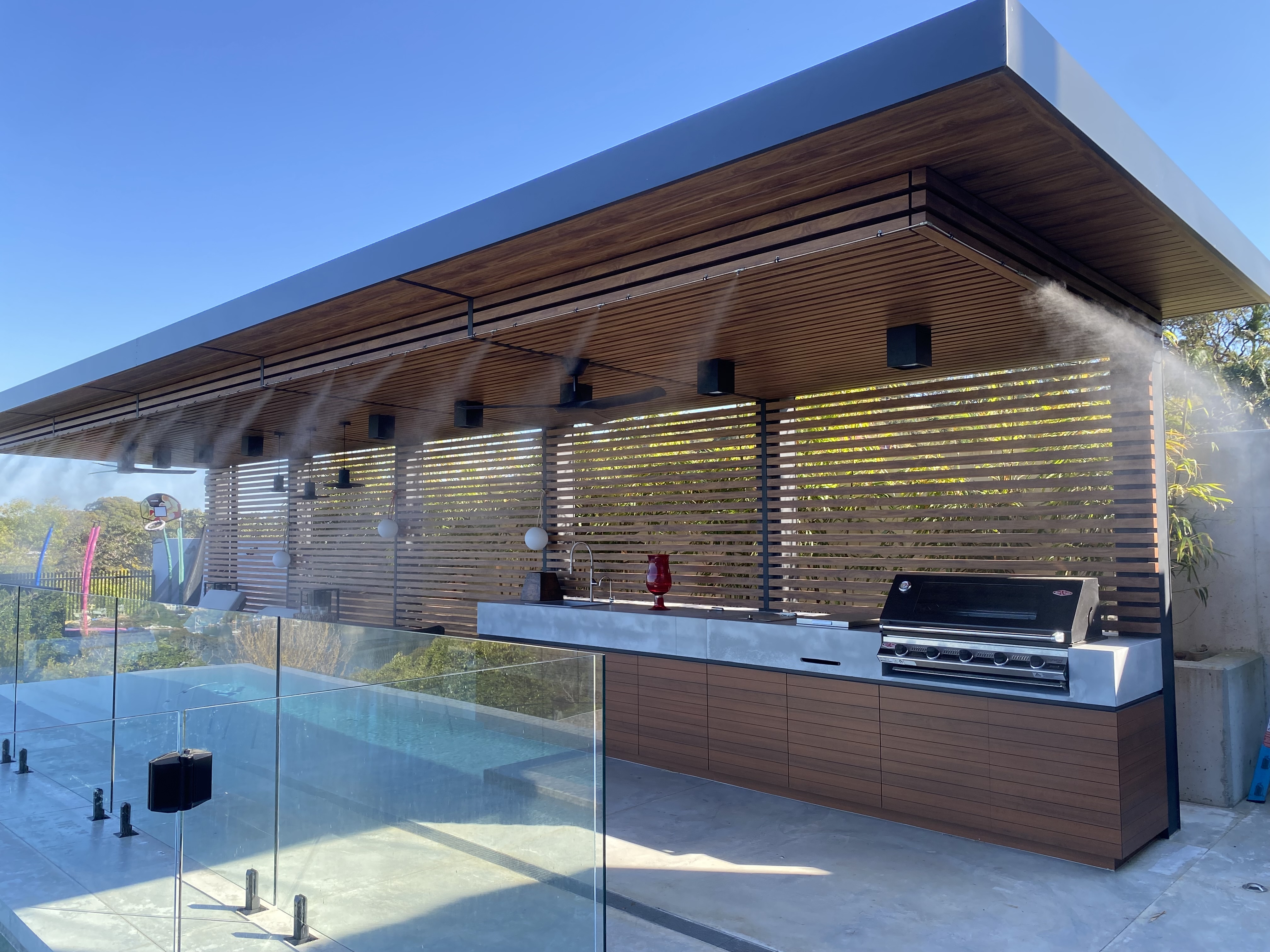 Fixed perimeter misting lines at luxury outdoor kitchen
