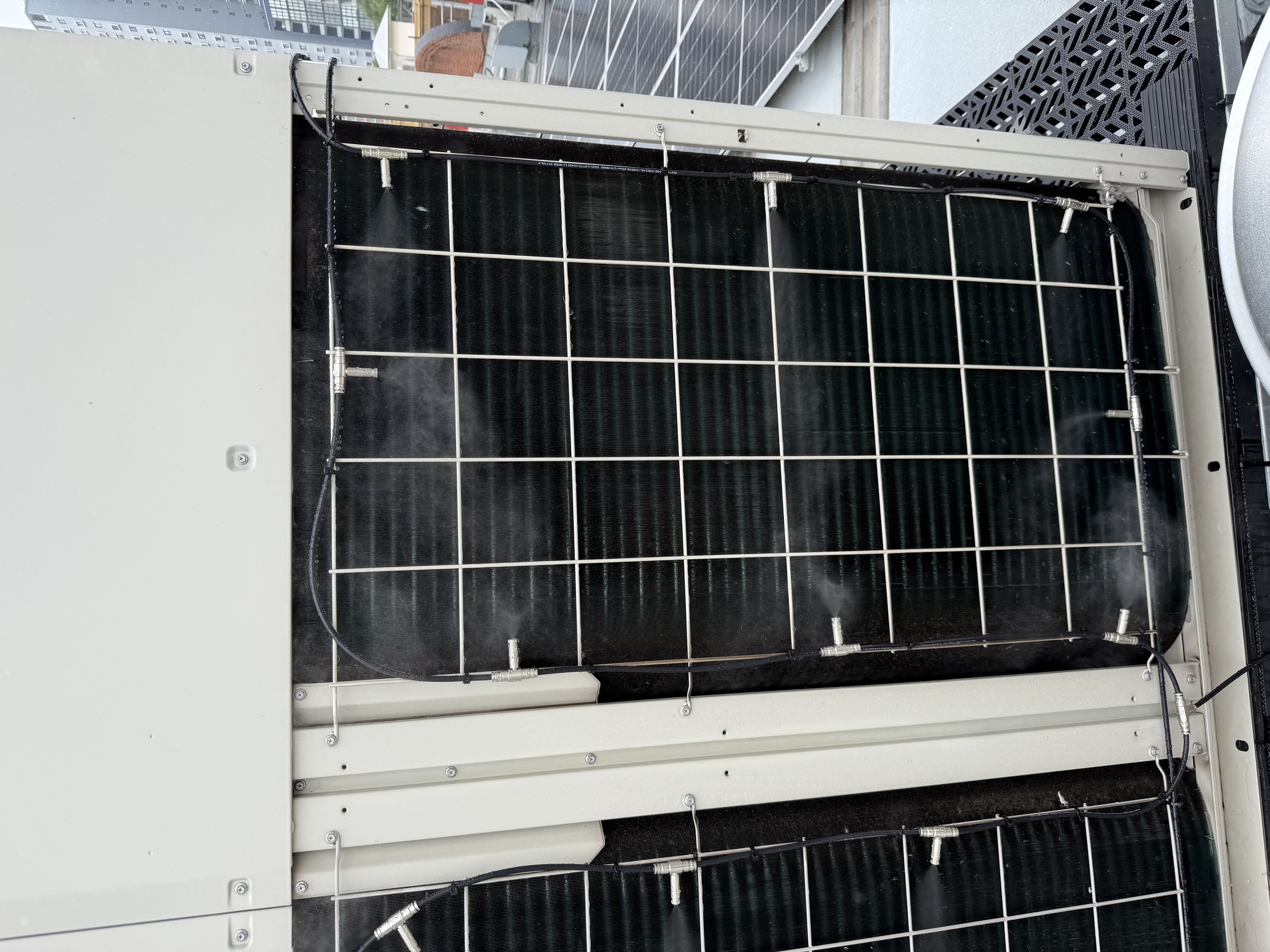 HVAC condenser unit with pre-cooling misting array