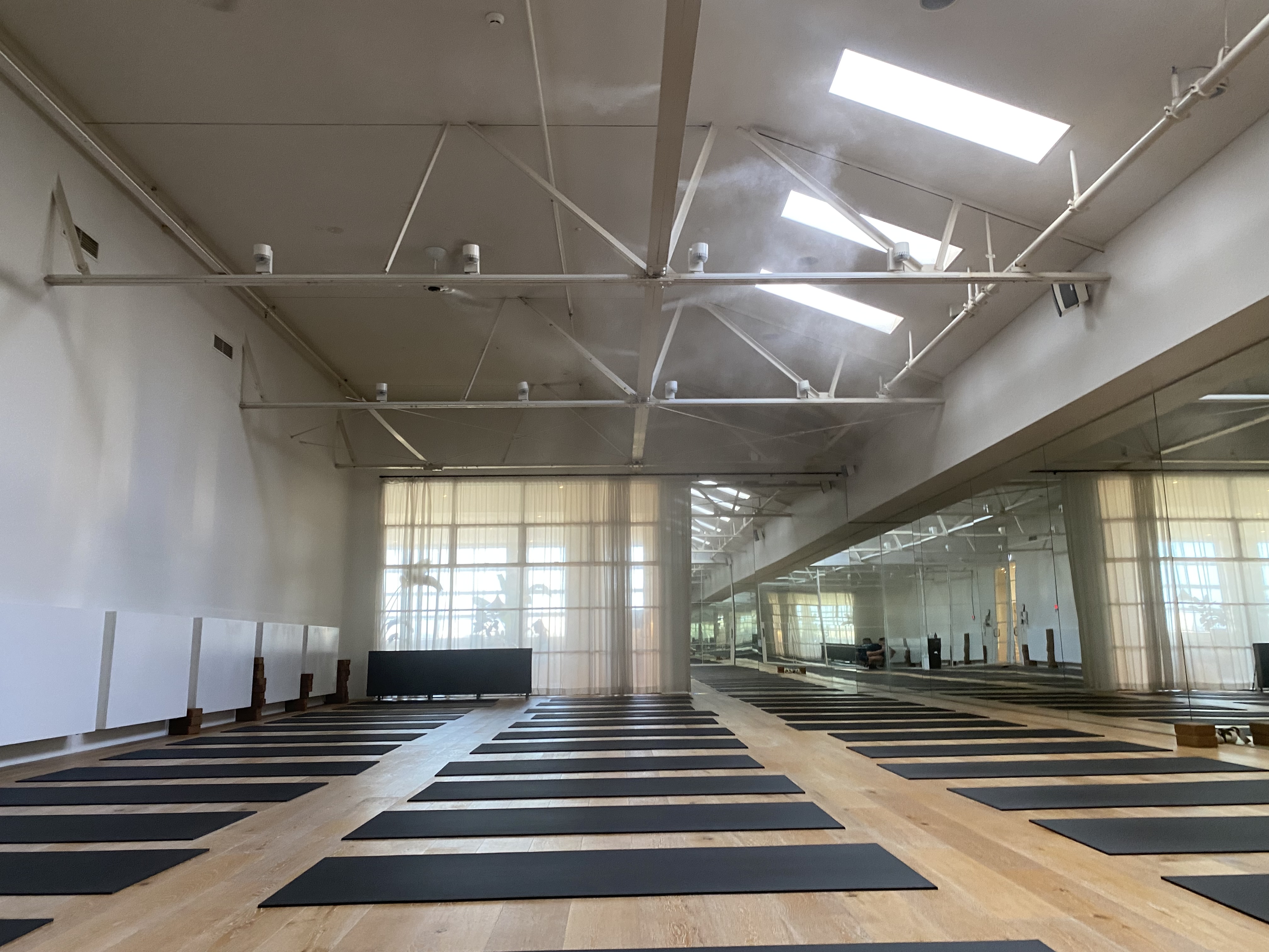 High-pressure misting nozzles in hot yoga studio